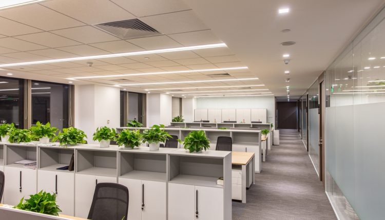 Corridor in modern style office. Empty tables, chairs and lockers