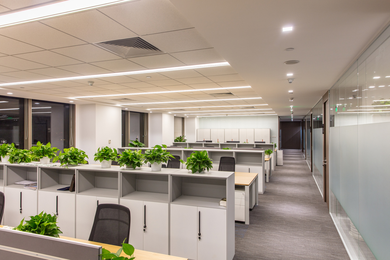 Corridor in modern style office. Empty tables, chairs and lockers