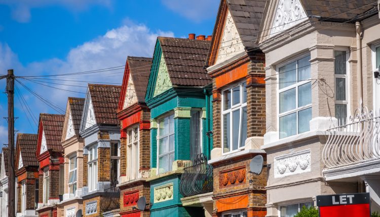 A row of colourful terraced houses around Kensal Rise in London with a LET sign