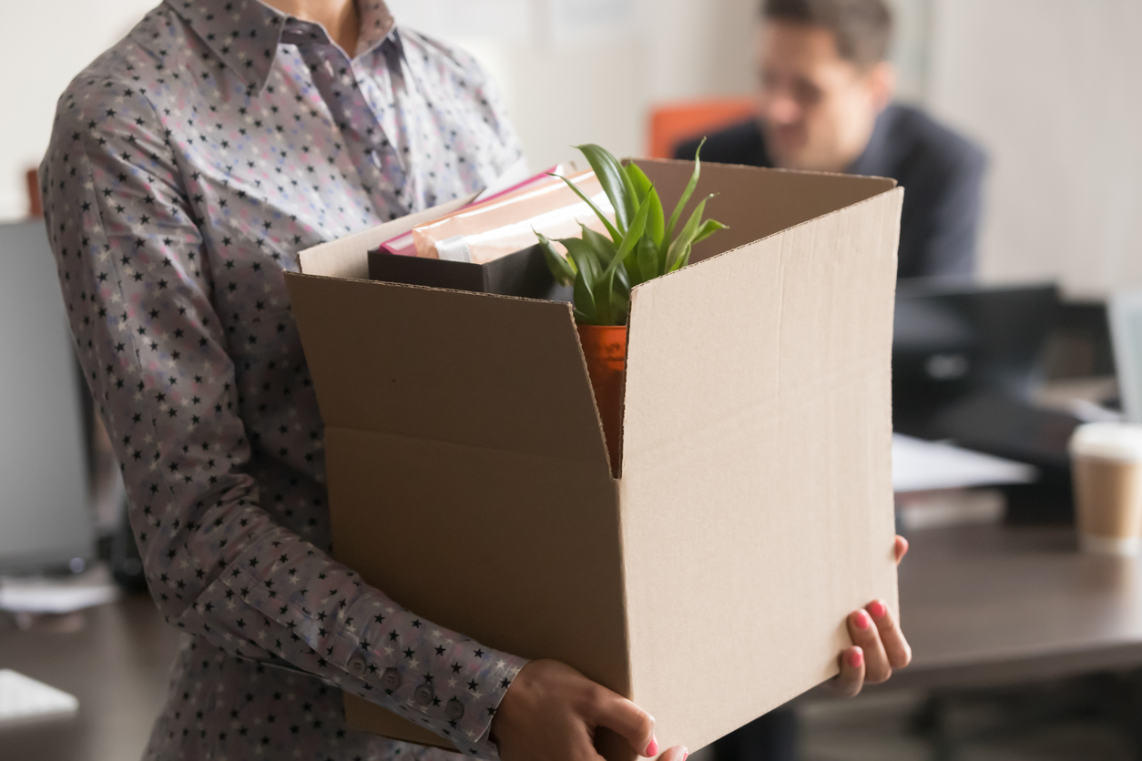 Close up view of new female employee intern holding cardboard box with belongings start finish job in company office, busnesswoman newcomer worker get hired fired on first last day at work concept