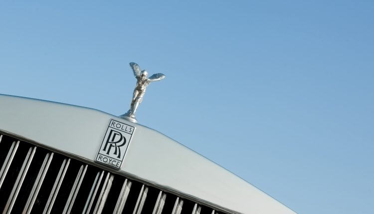 "Rushmoor, UK - April 22, 2011: The Rolls Royce Spirit of Ecstasy vehicle hood mascot, sometimes known as The Silver Lady was designed by Charles Robinson Sykes; and is one of the worlds most recognisable corporate images."