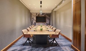 An image of of a conference table in the conference room of a hotel.