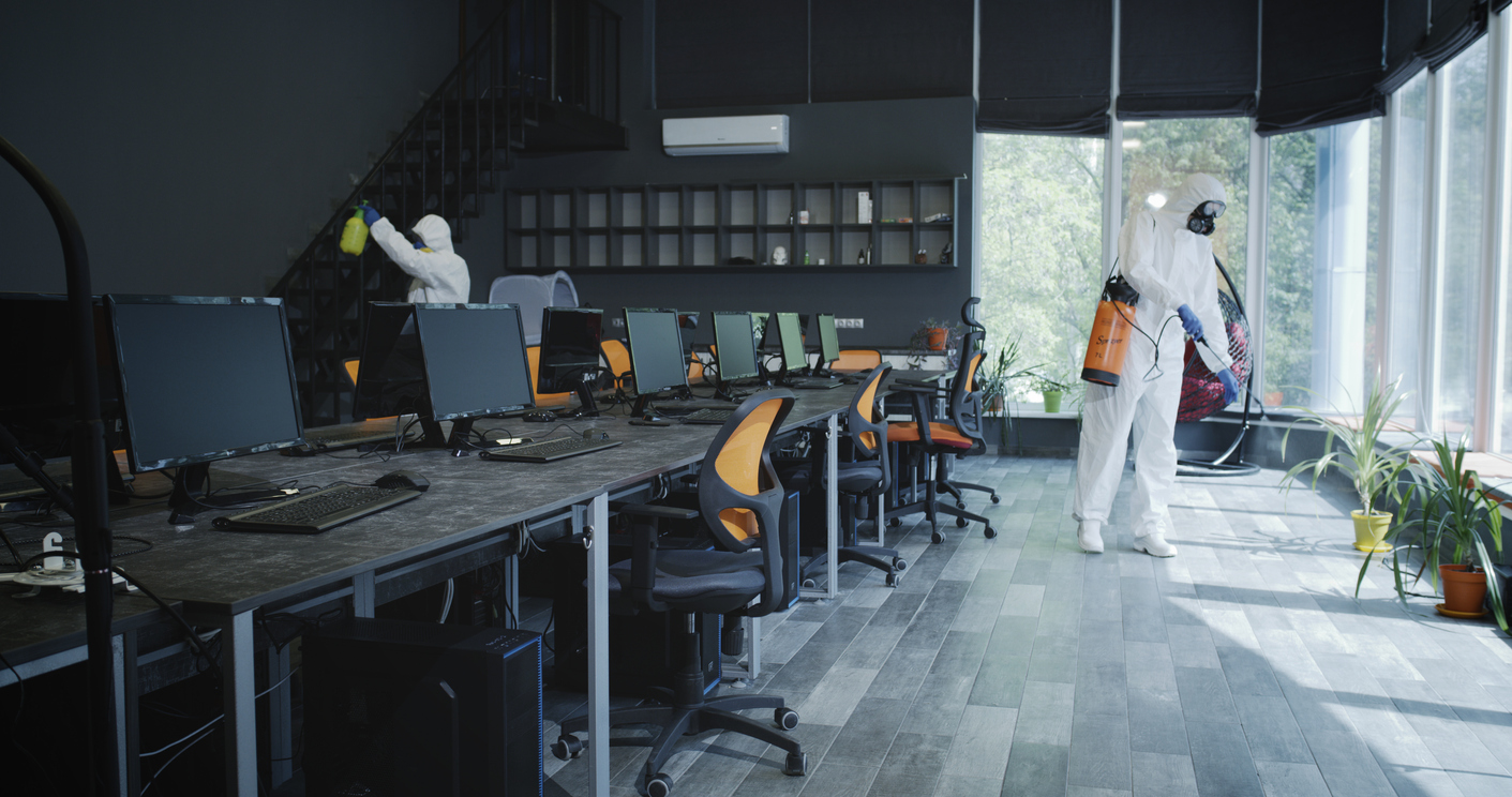 Men in hazmat suits disinfecting office