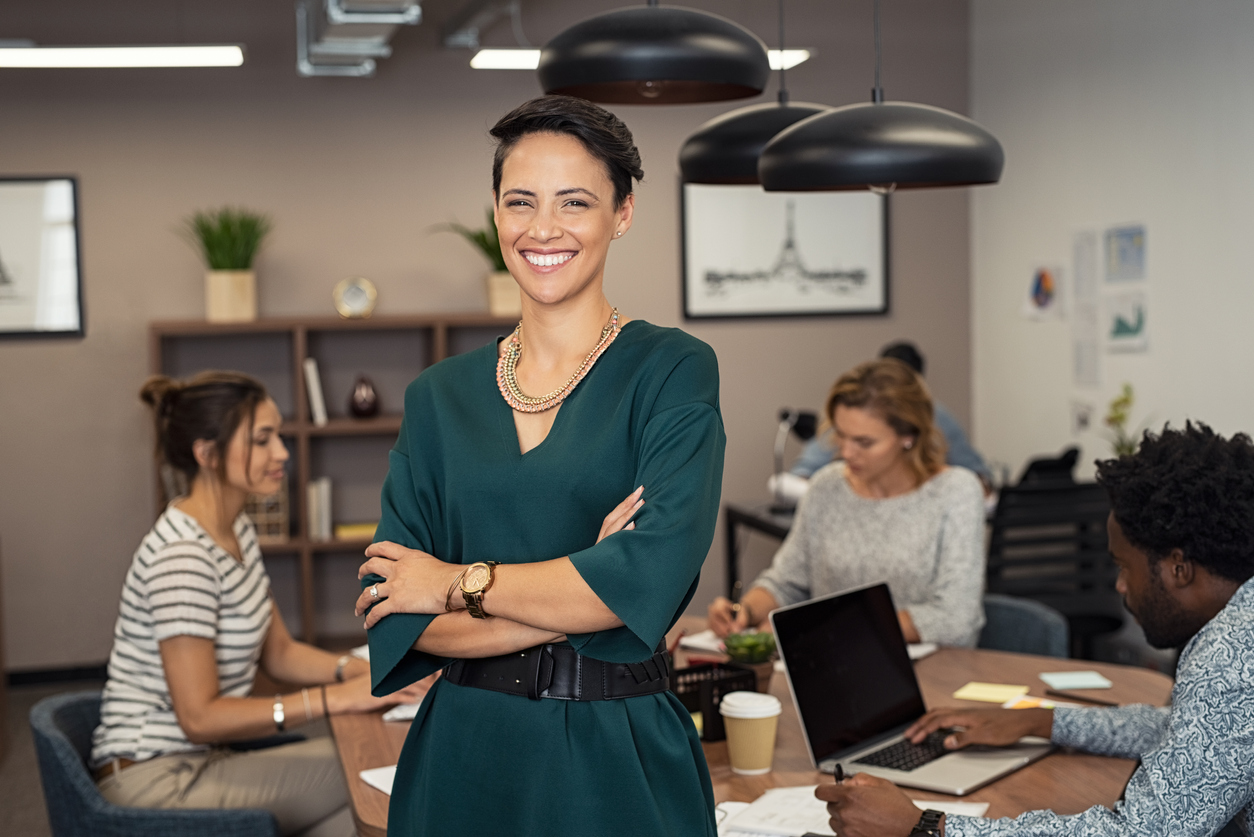 Successful business woman stood infront of team