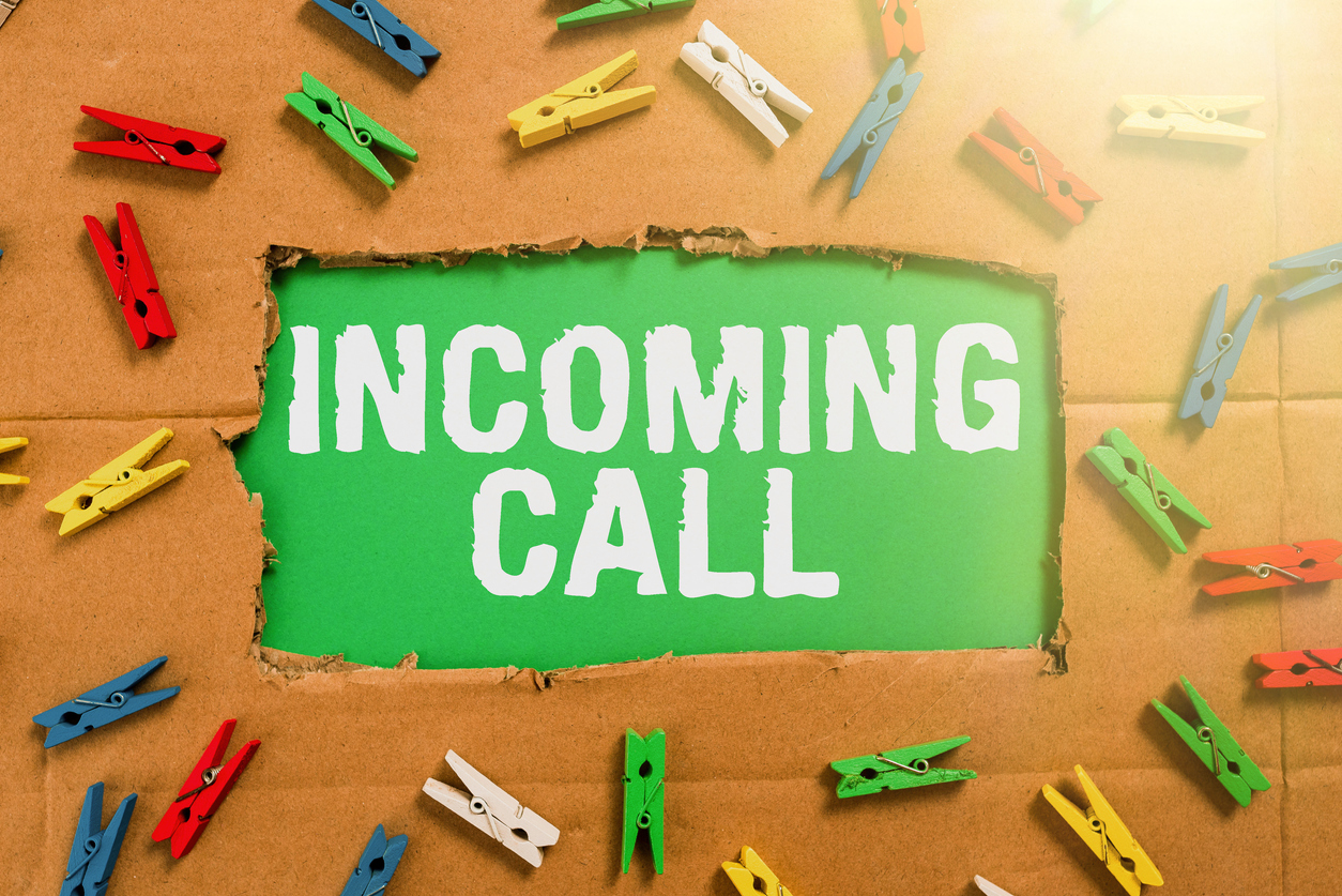 Hand writing sign Incoming Call, Concept meaning Inbound Received Caller ID Telephone Voicemail Vidcall Important Ideas Written Under Ripped Cardboard With Colored Pegs Around.