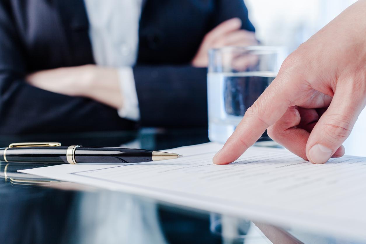 Male Hand Pointing a Place to Sign a Paper