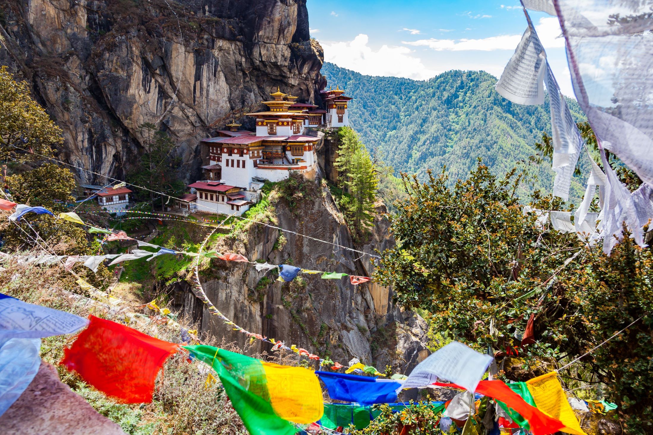 A landscape image of Bhutan and a monastery in the Himilayas
