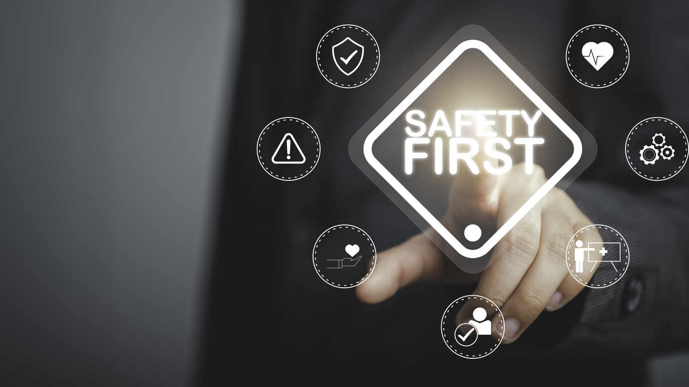 work safety concept. businessman touching safety first text . safety first sign on virtual screen. hazards, protections, regulations and insurance, zero accidents, protection dangerous.