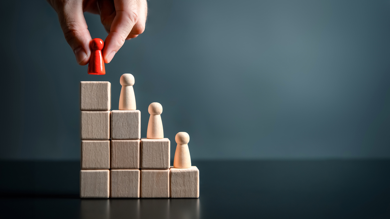 businessman hand placing red wooden man doll on top of ladder on black background. climbing stairs success business leadership career growth opportunities performance progression step concept.