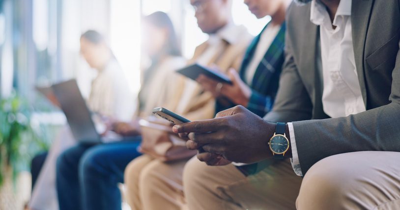 recruitment, hiring and phone with hands of business people in waiting room for networking, social media and job interview. technology, communication and meeting with closeup of employees in office
