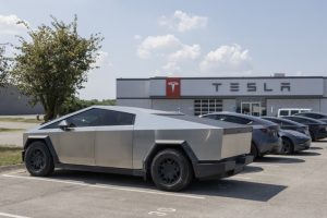 tesla cybertruck display at a dealership. tesla offers the cybertruck with driving range of up to 340 miles.