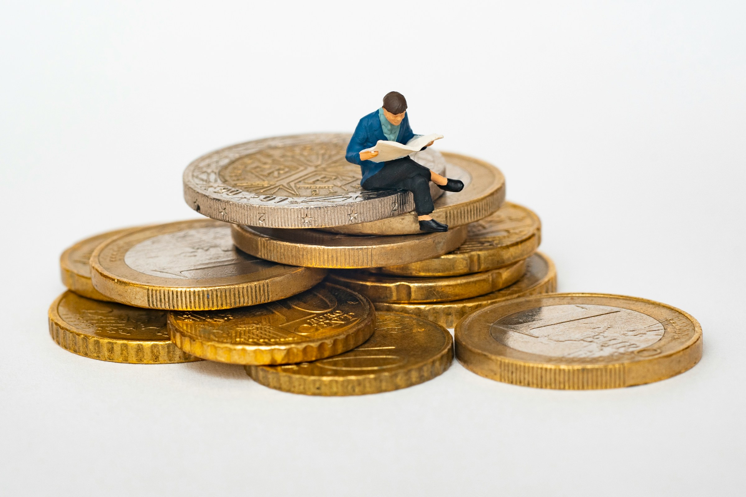 A pile of coins with a toy figure sat on top.