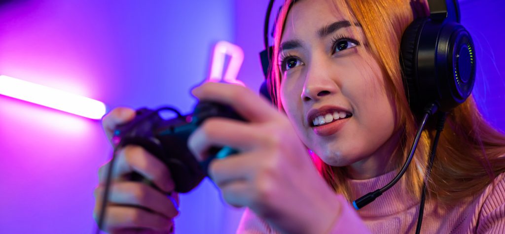 gamer using joystick controller plays online video game with computer neon lights she winning