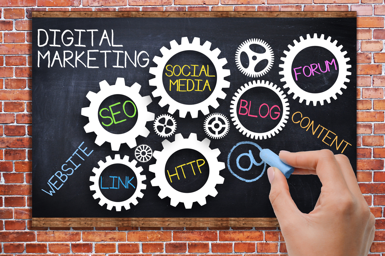 digital marketing concept with spinning gears on blackboard