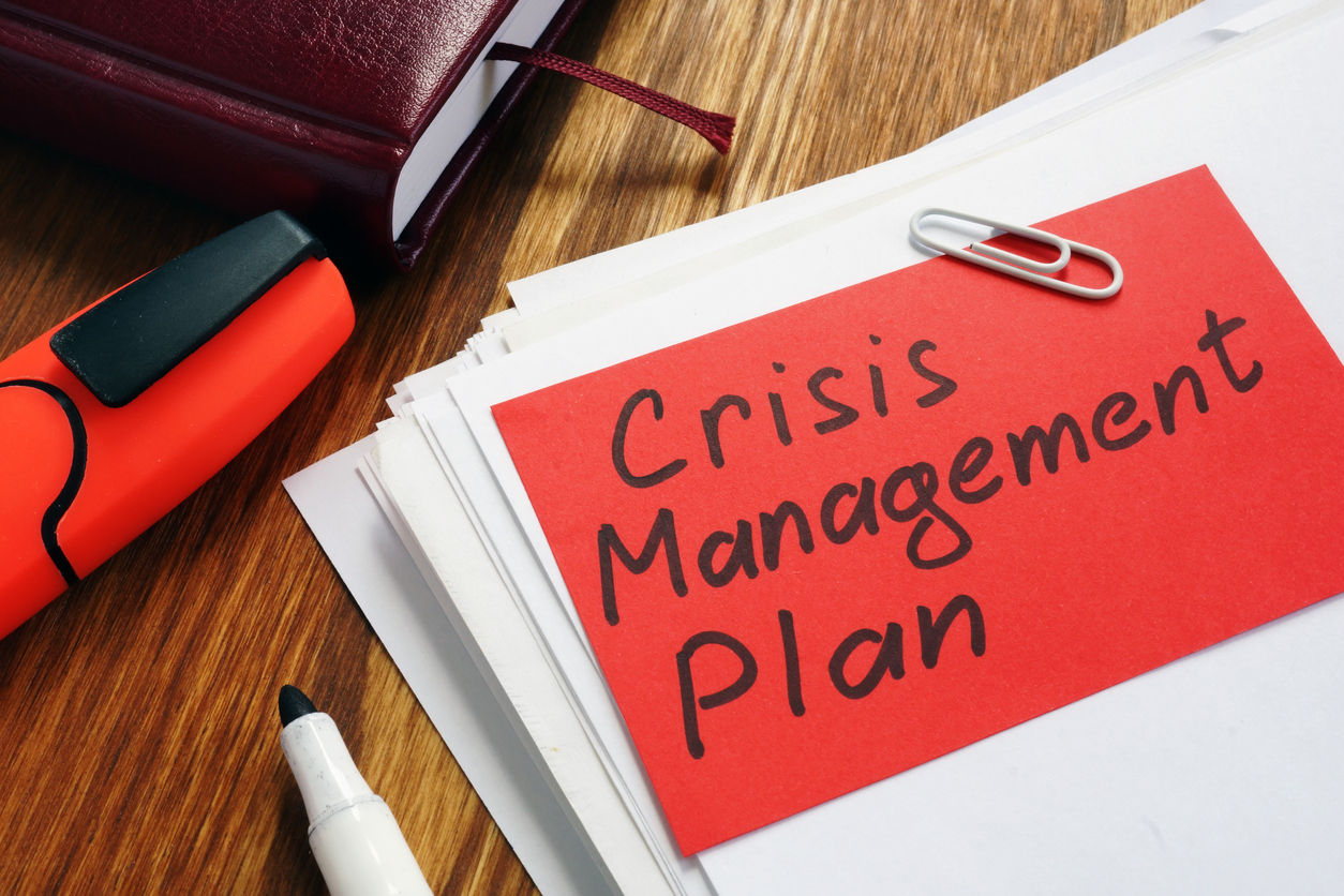 crisis management plan on an office desk and papers.
