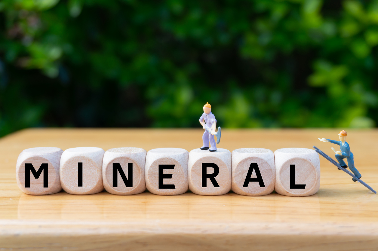 concept of mineral extraction and international commodity prices.nuggets.make money.supplier of minerals for production.written word on dice,miniature workers digging. search business opportunities