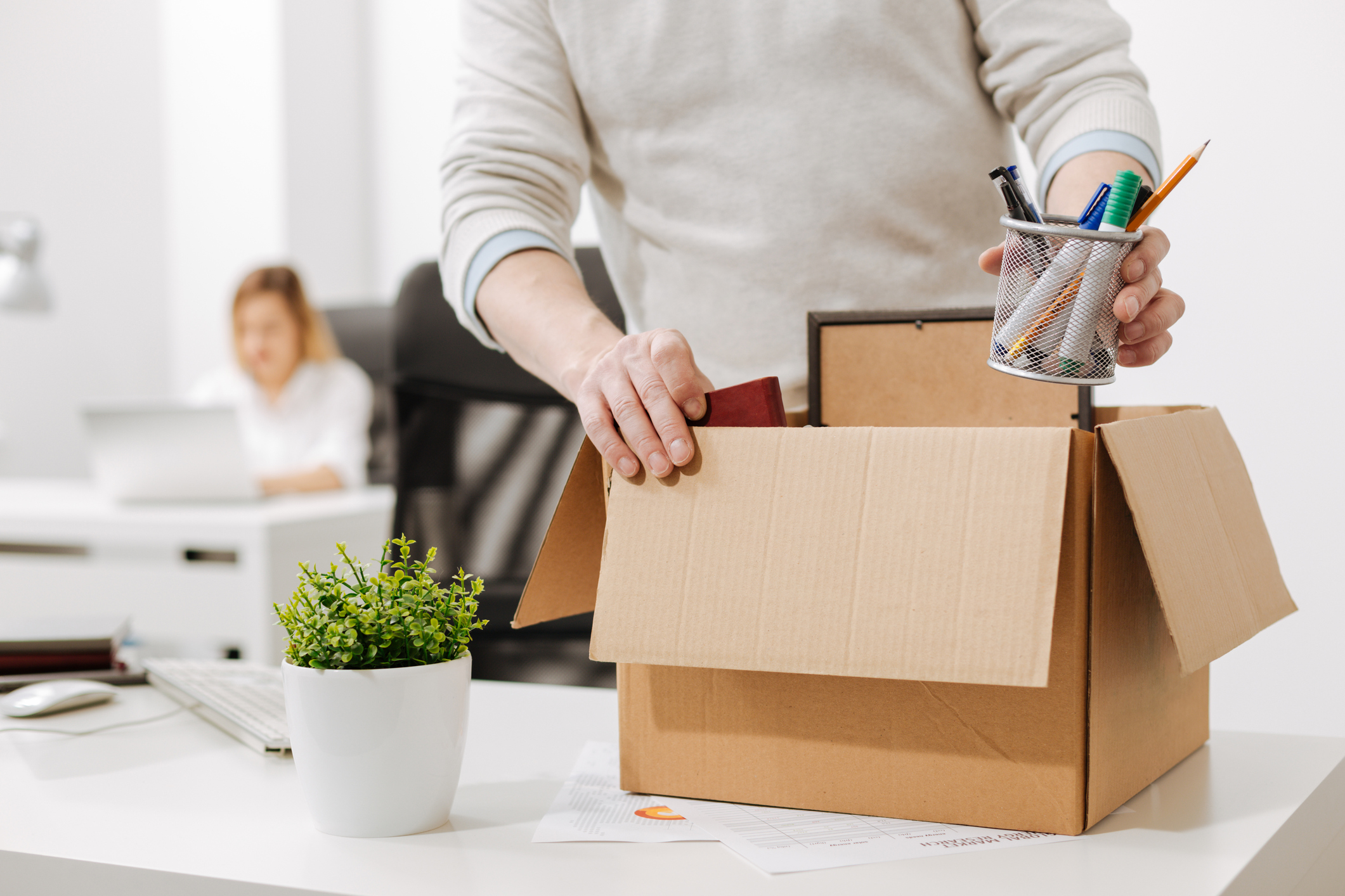 upset office manager packing the box and leaving the office