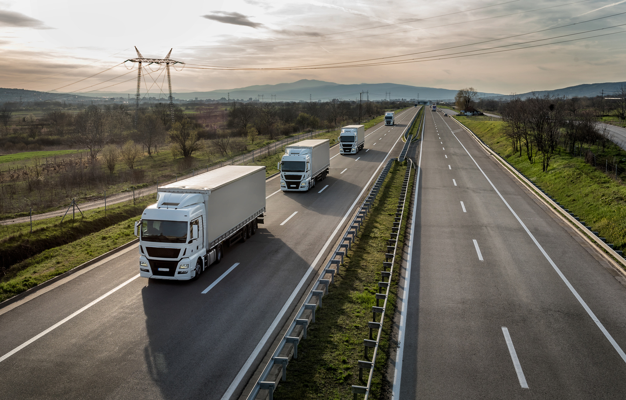 caravan or convoy of trucks on highway