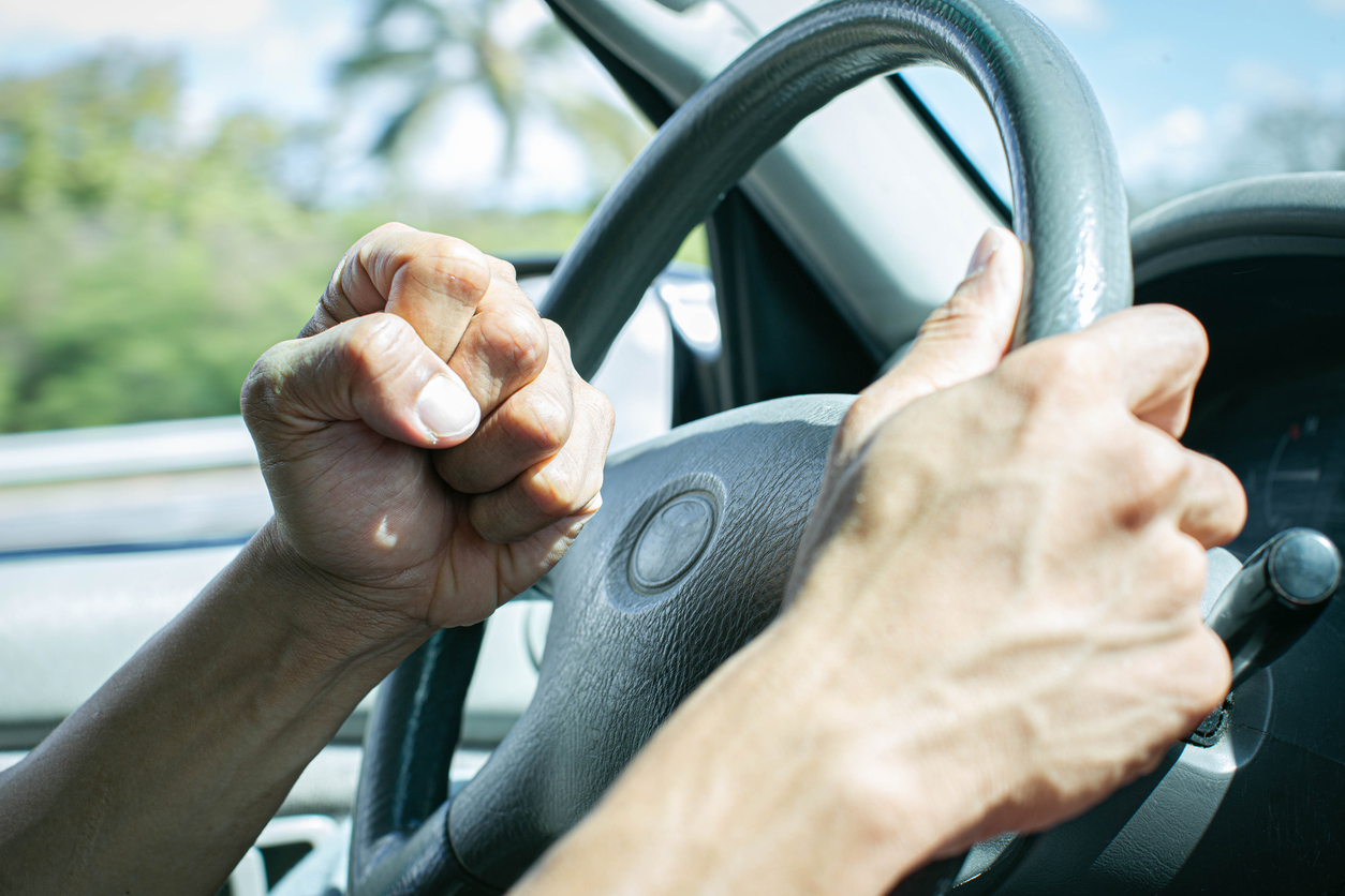 angry driver honking and beeping the horn. road rage.