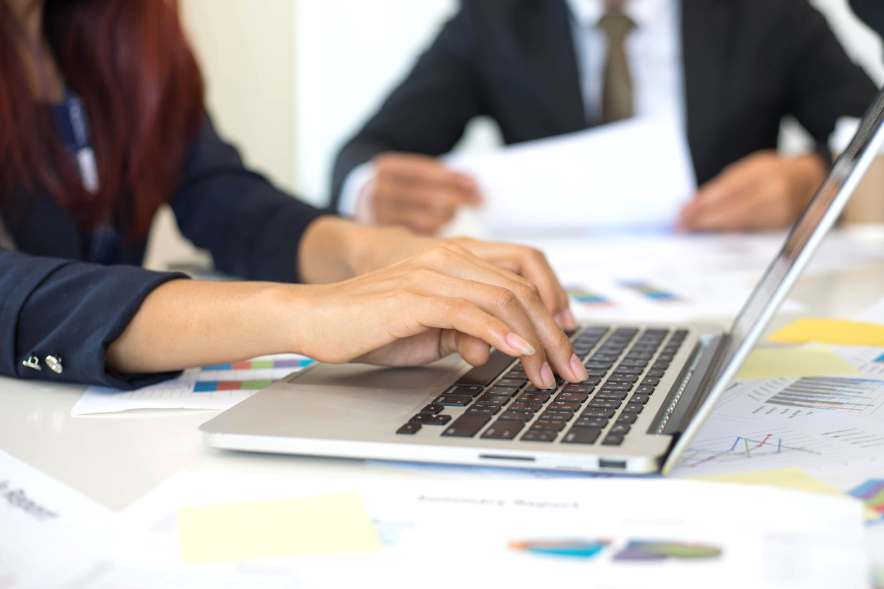 close up hand of business woman employees secretary using laptop minutes of executive meeting business concept