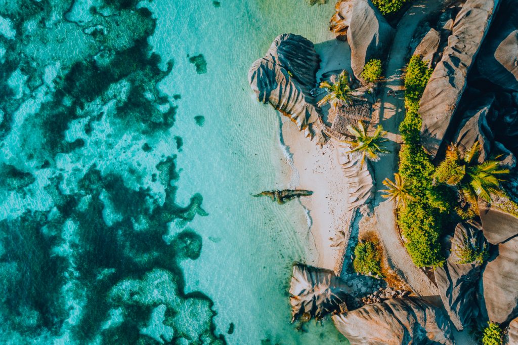 aerial photo of famous paradise like tropical beach anse source d argent at la digue island, seychelles. summer vacation, travel and lifestyle concept