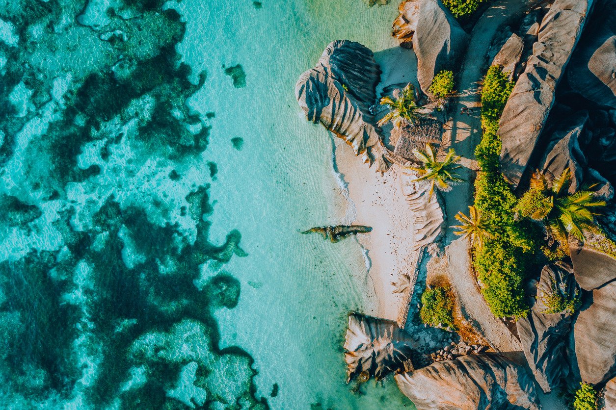 aerial photo of famous paradise like tropical beach anse source d argent at la digue island, seychelles. summer vacation, travel and lifestyle concept