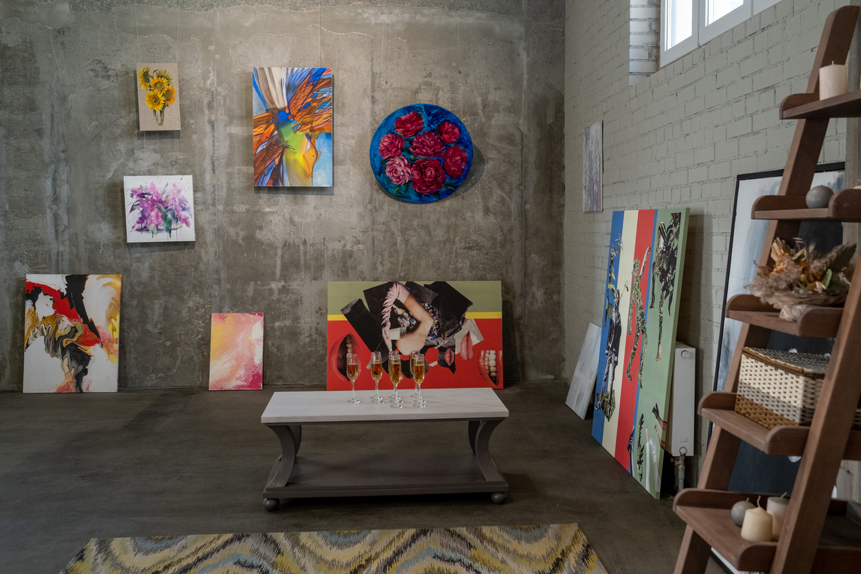 collection of paintings of modern artists on walls of gallery