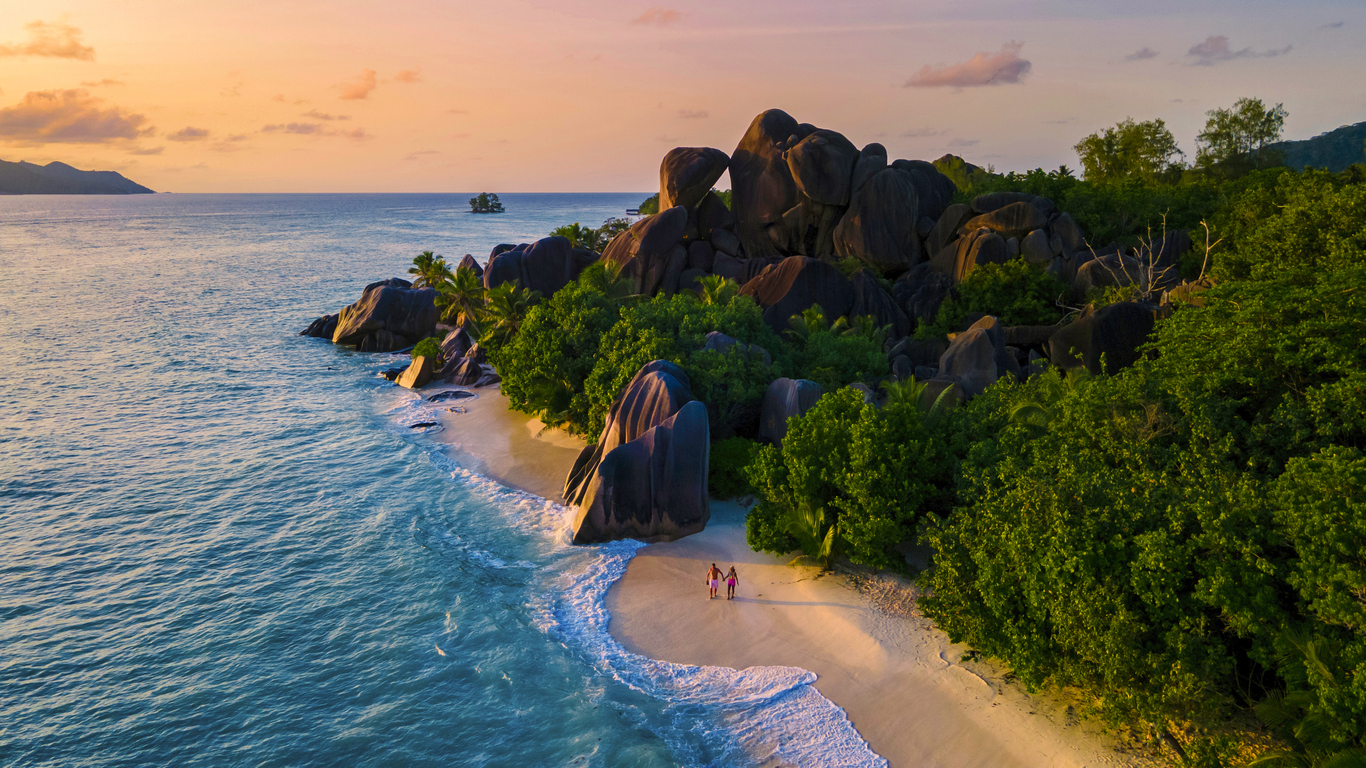 anse source d'argent, la digue seychelles, young couple men and woman on a tropical beach