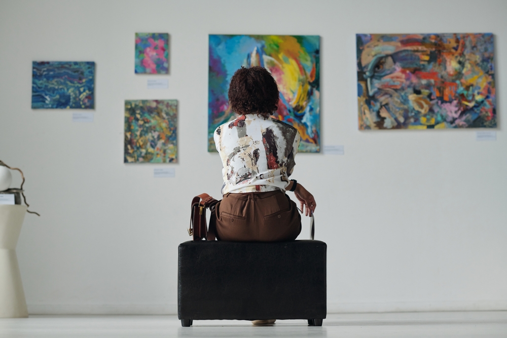 rear,view,of,young,woman,sitting,on,couch,and,looking