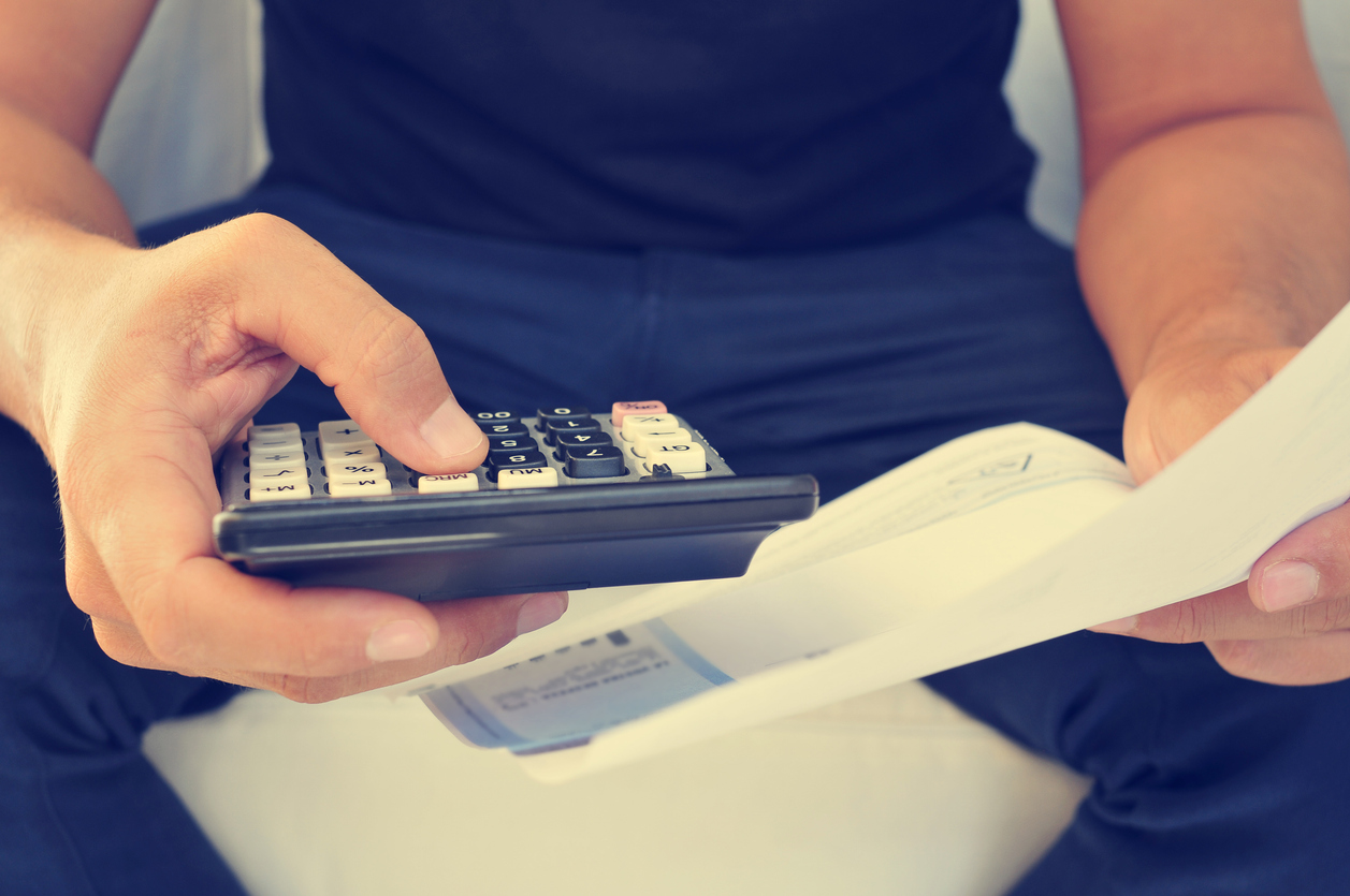 young man checking a bill, a budget or a payroll, filtered