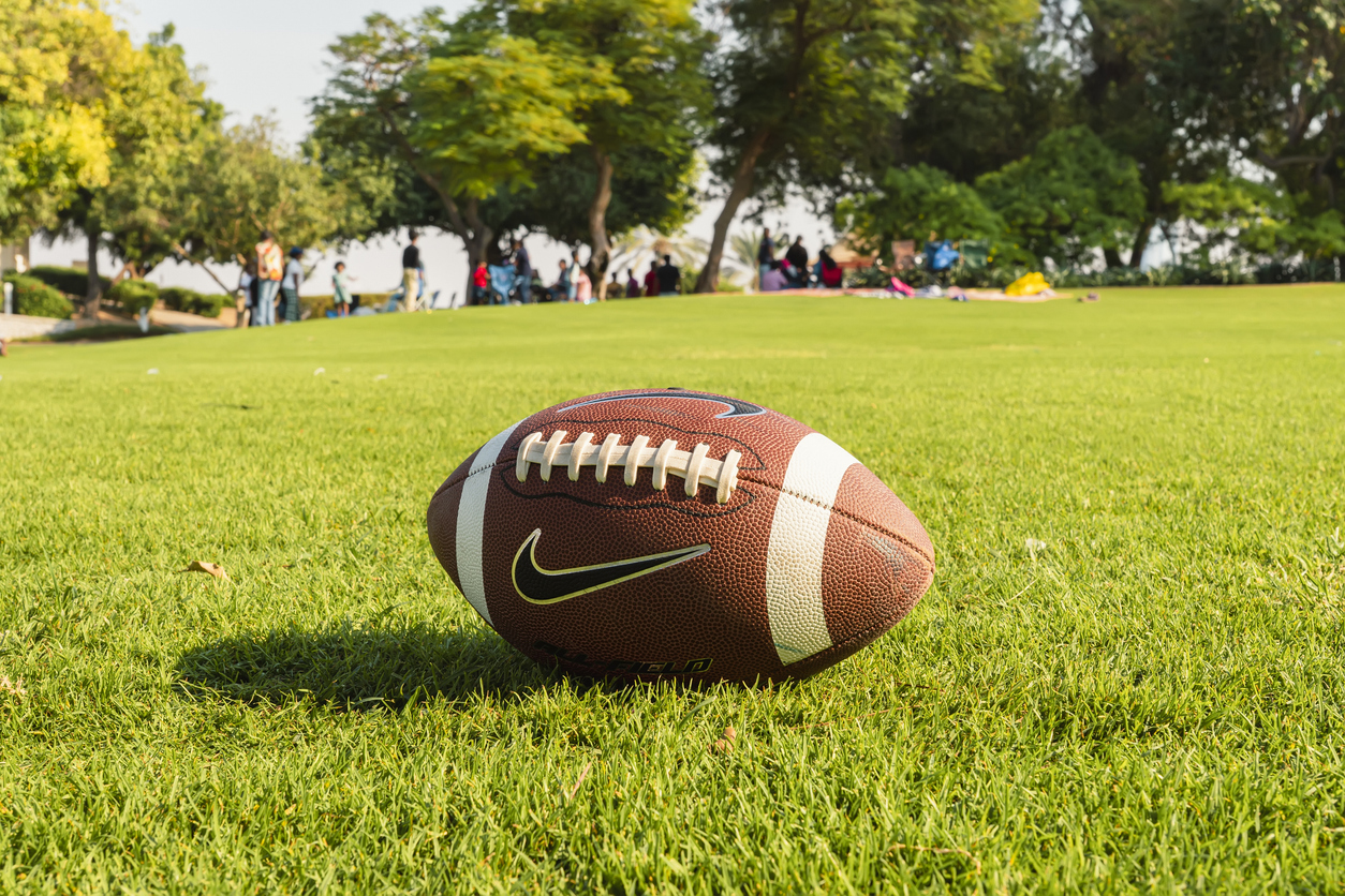 rugby ball on a patch of grass. a national sport in the united states of america.