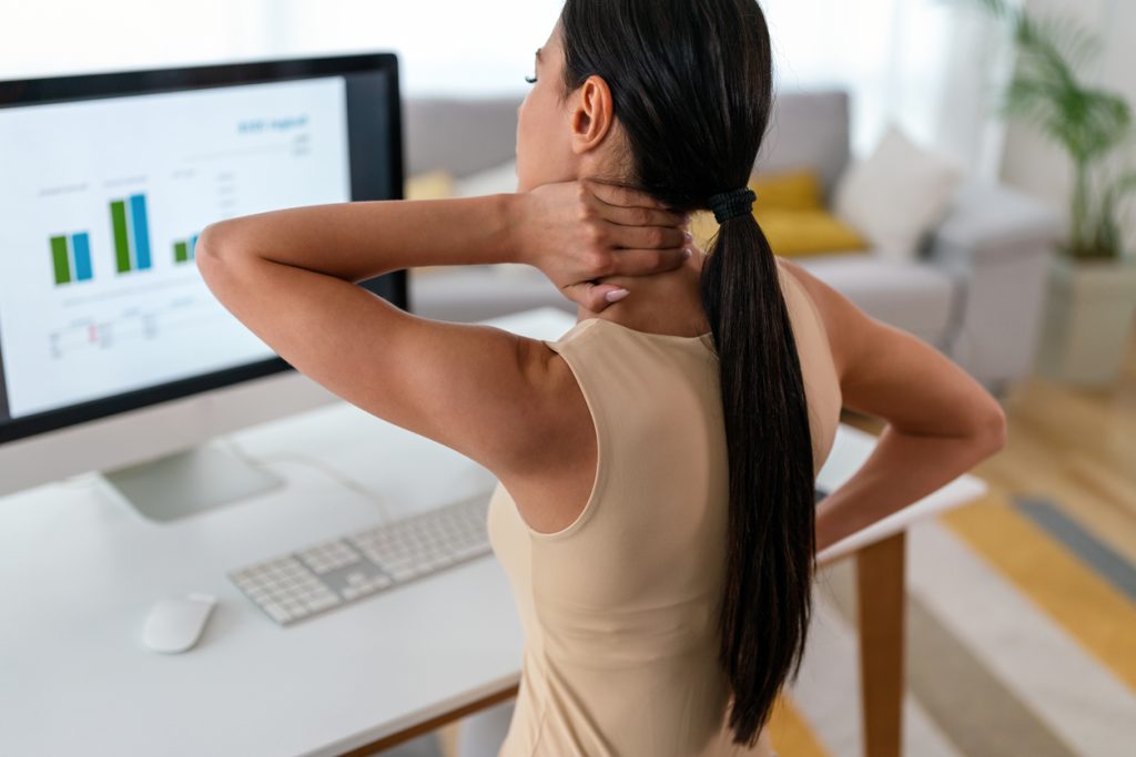 tired woman massaging rubbing stiff sore neck tensed muscles fatigued from computer work
