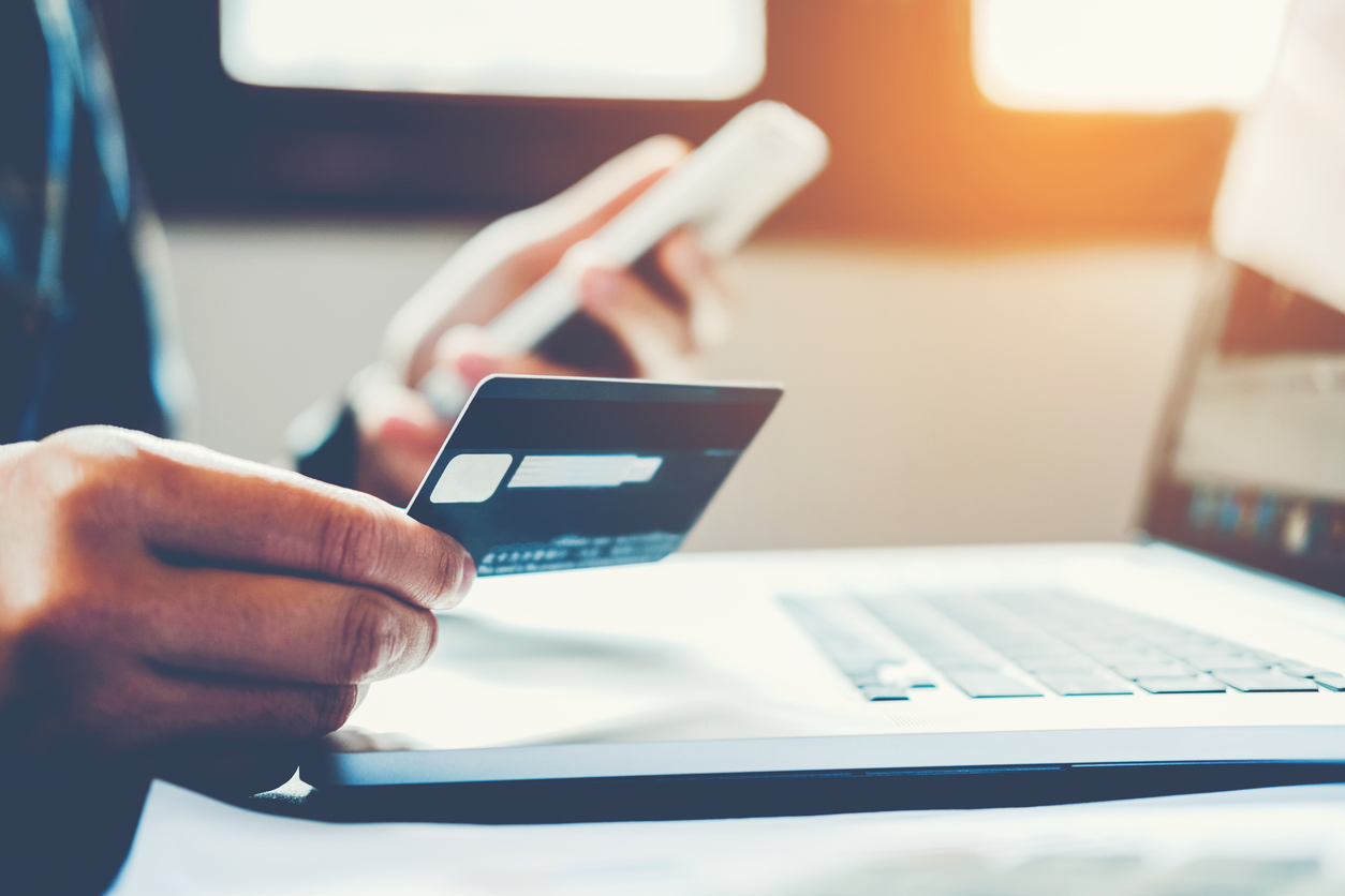 man holding credit card and using cell phone holding credit card with shopping online