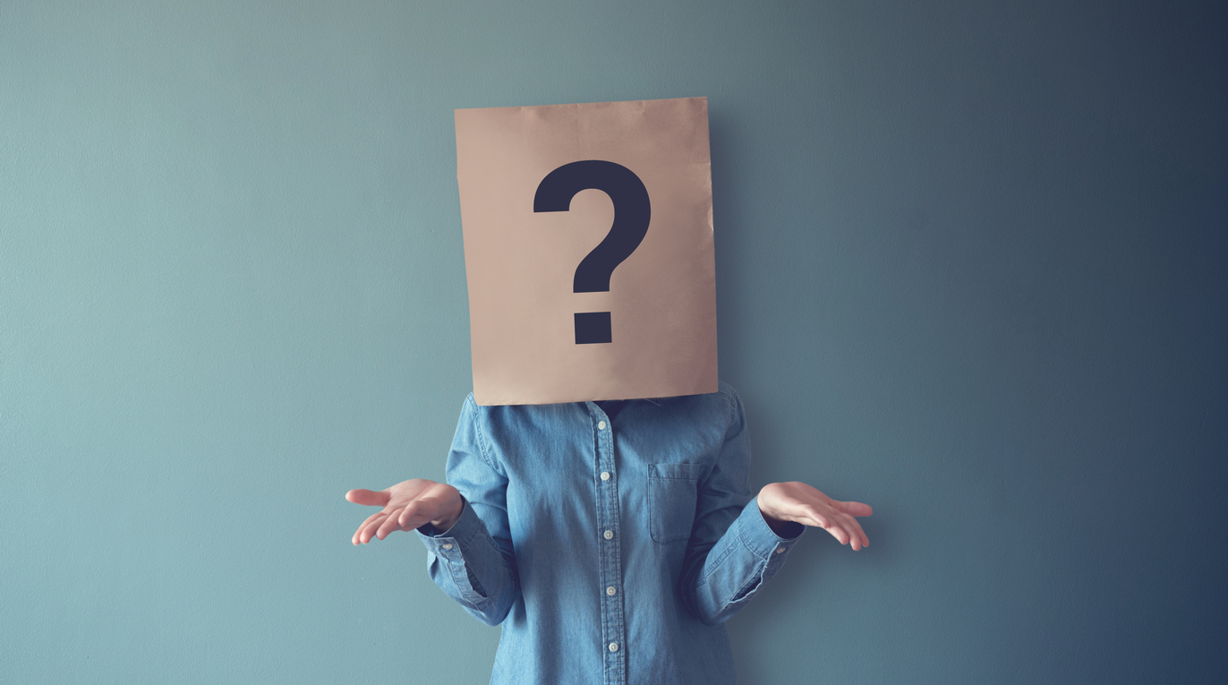 woman has confused, thinking, question mark icon on paper bag, copy space.
