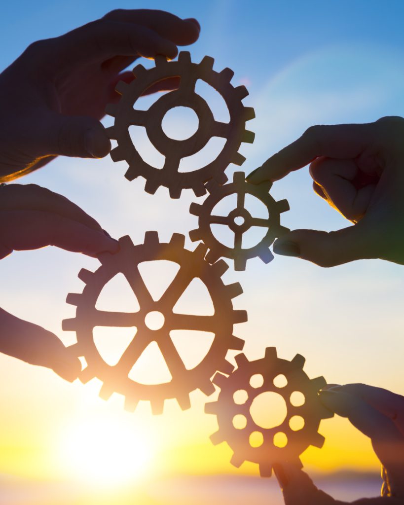 four hands of businessmen collect gear from the gears of the details of puzzles.