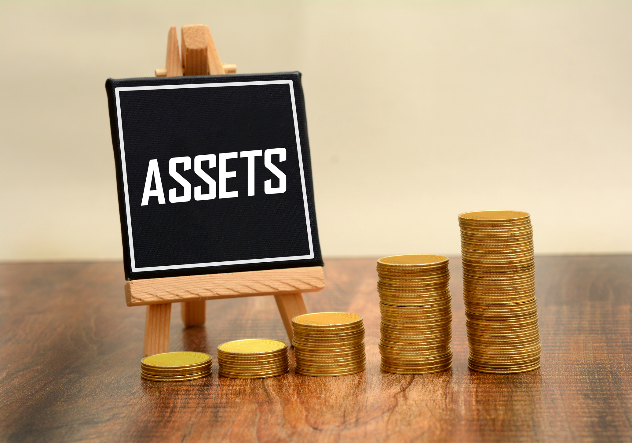 asset sign with gold currency coins stack