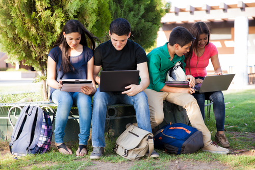 group,of,teenagers,social,networking,using,several,tech,devices,in