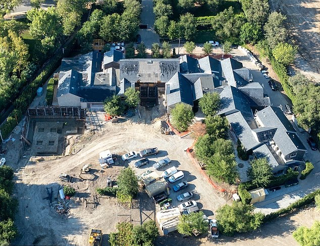Aerial view of Kim Kardashian’s sprawling Hidden Hills estate under renovation, showing multiple connected buildings, construction vehicles, and surrounding trees.