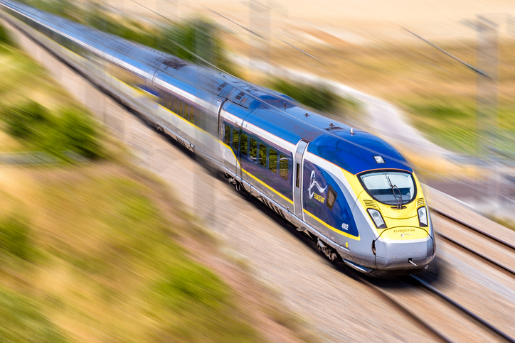 a eurostar high speed train at full speed in the countryside with motion blur.
