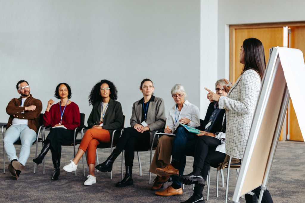 business colleagues attending a conference for upskilling and professional development