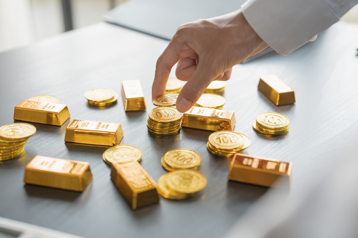 gold trading business man hand offering goldÂ investment in gold mining company or trading gold on the stock exchangeÂ rising gold prices.