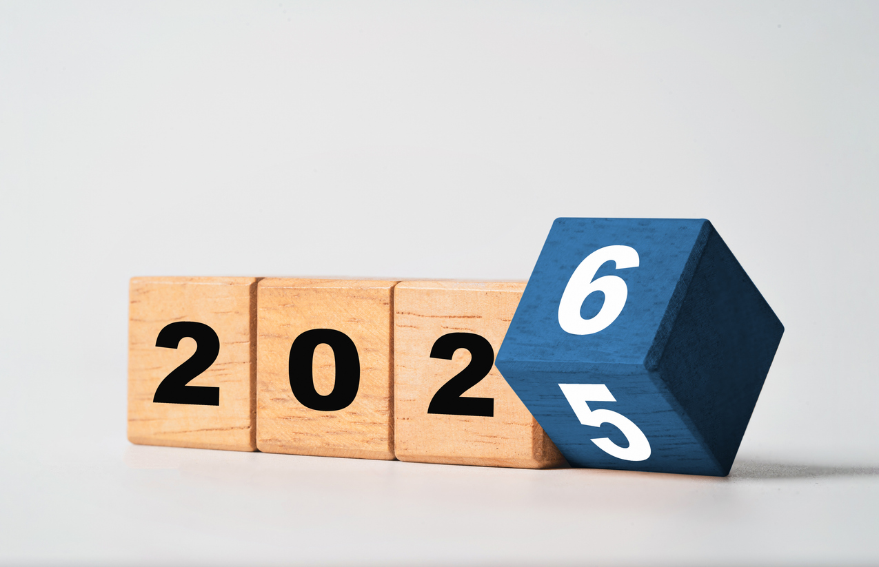 flipping of 2025 to 2026 on wooden block cube for preparation new year change and start new business target strategy concept.