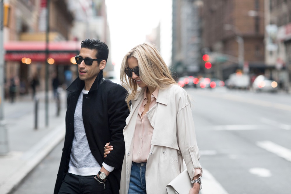 Couple wearing neutral-toned jackets with clean lines and understated styling