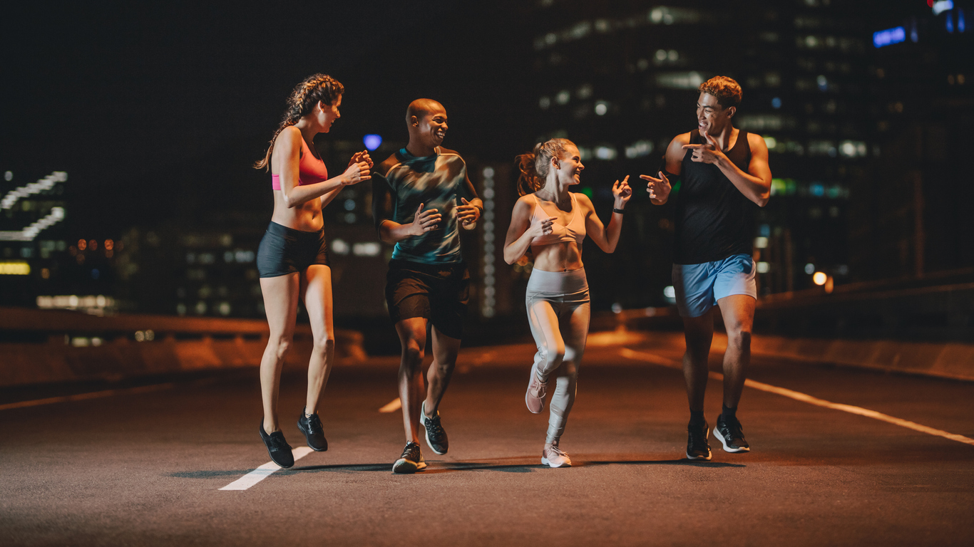 runners training together outdoors in evening