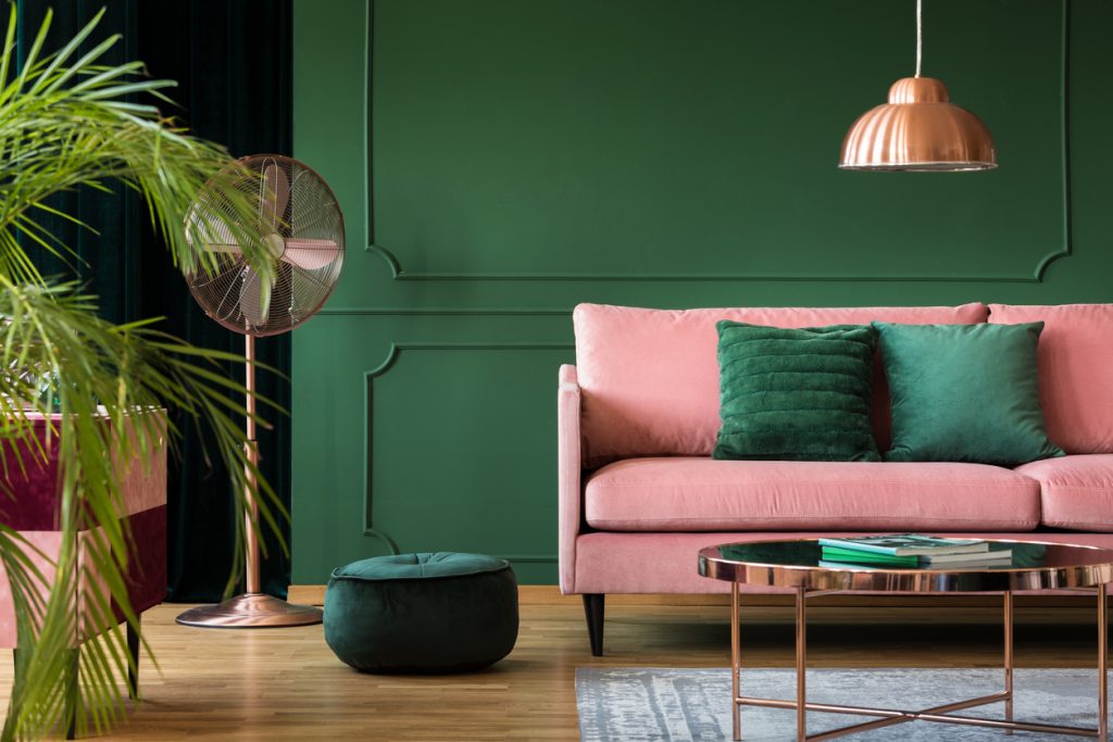copper lamp and table in a green living room interior. real photo