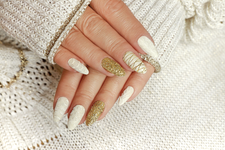 knitted sand manicure on long oval nails with golden sequins and threads
