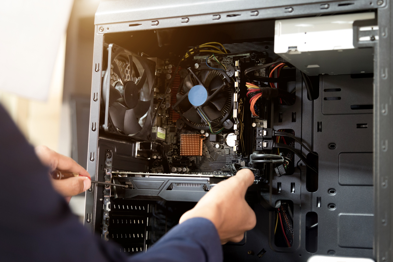 technician with a screwdriver for fixing computers, computer