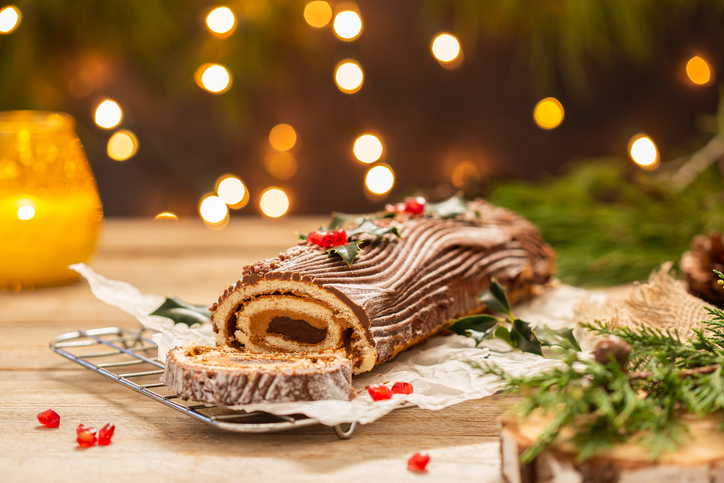 traditional christmas cake, chocolate yule log with festive decorations