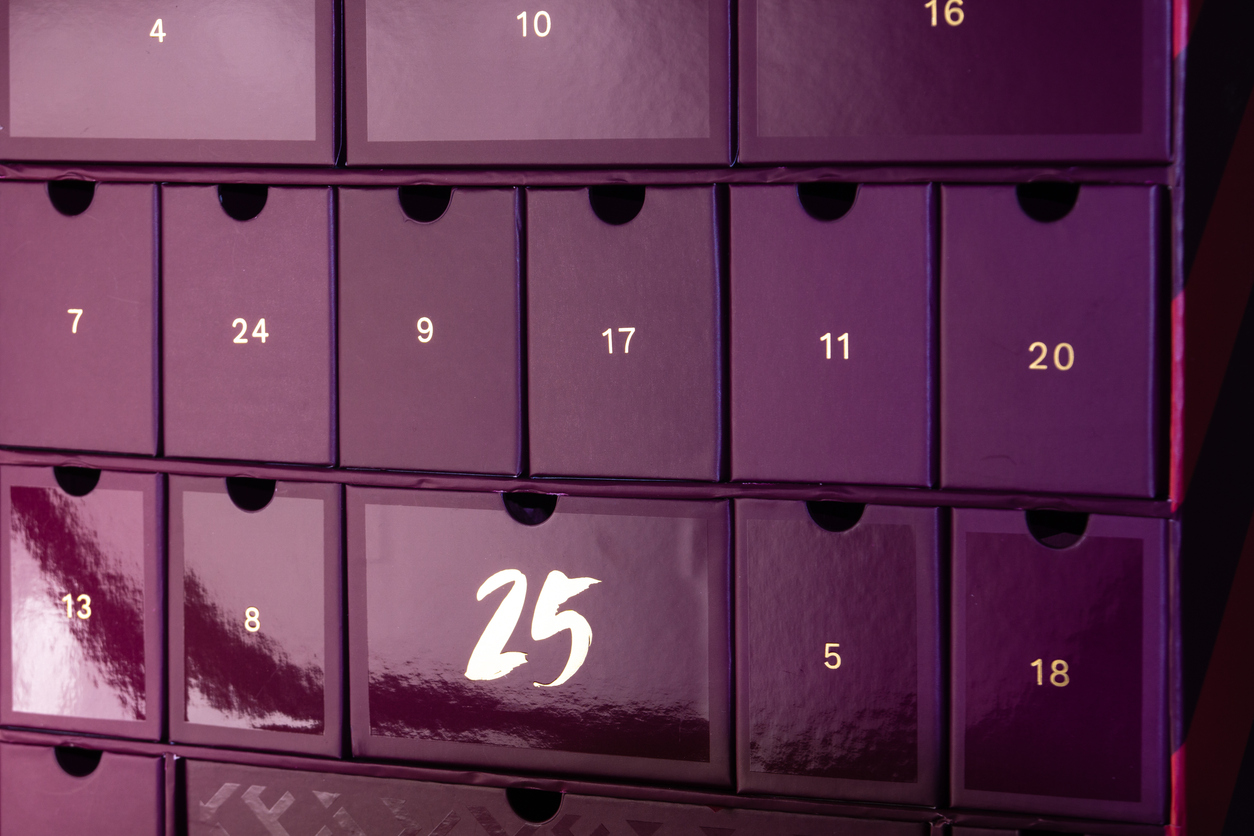 burgundy advent calendar. cells with numbers of different sizes. a christmas gift.