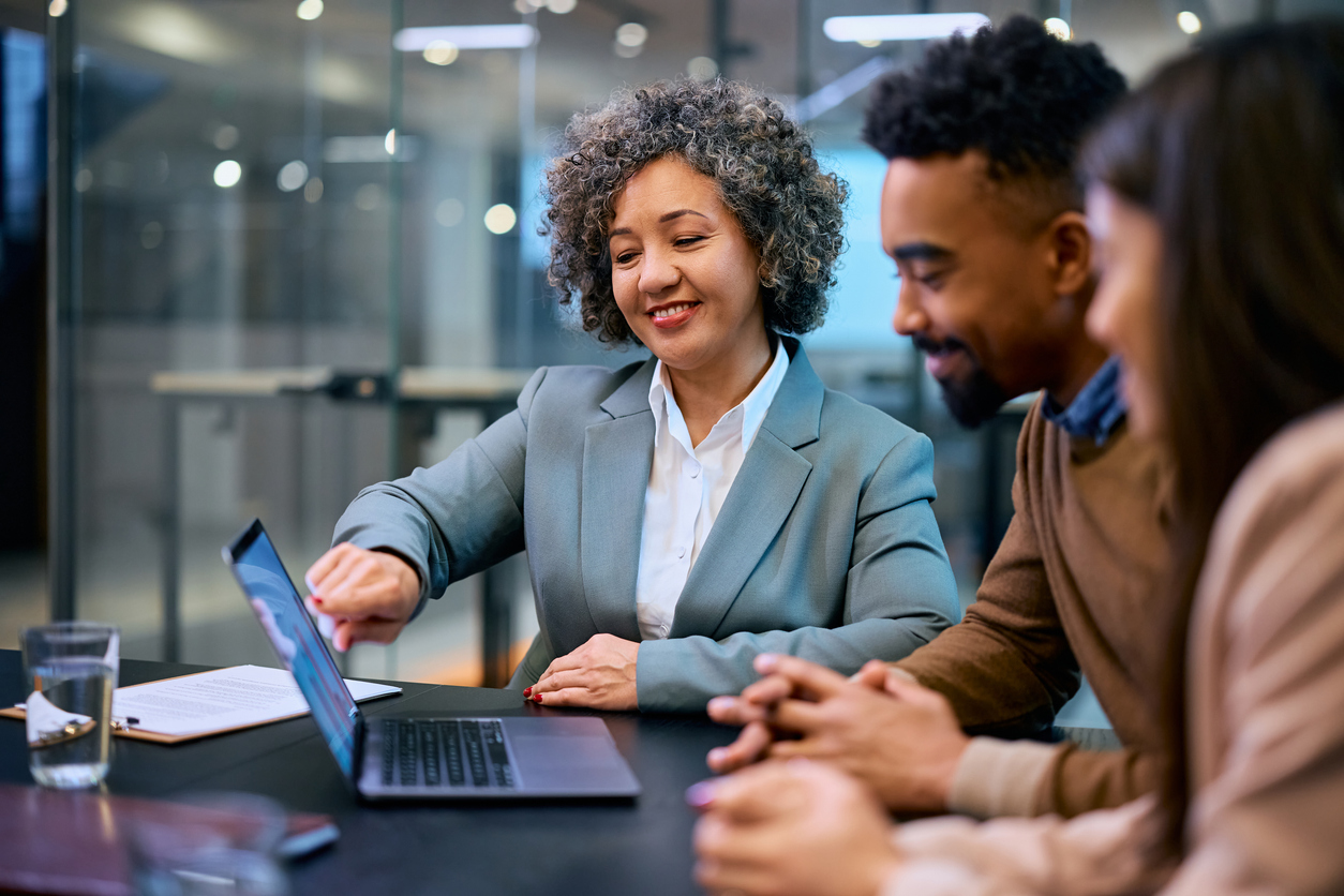happy insurance agent and black couple using laptop during a meeting in the office.